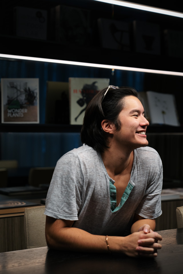 Christopher smiling at a table.